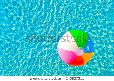 colorful beach ball floating in a pool