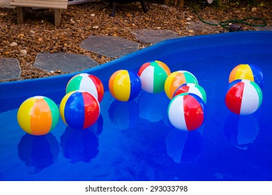 Colorful Beach Balls Floating In Pool