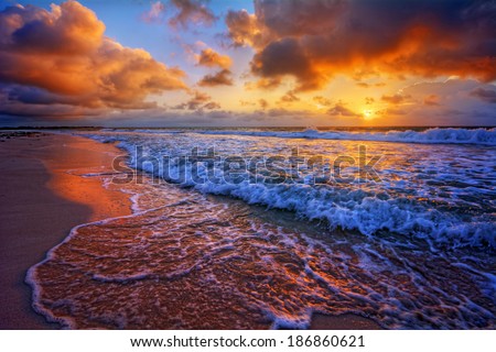 Colorful beach destination sunrise or sunset with beautiful breaking waves