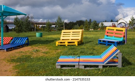 Colorful Beach Furniture Made From Used Pallets On A Beach With A Green Lawn. Concept Of Reuse, Upcycling, Modern Summer Beach Holiday. 