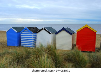 Colorful Beach Huts In British Seaside