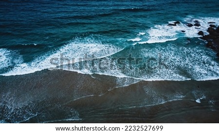 Similar – Aerial Drone View Of Blue Ocean Waves And Beautiful Sandy Beach Shore in Portugal