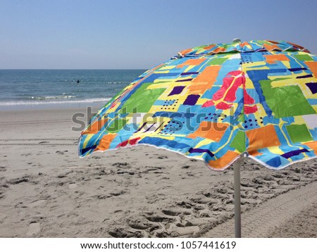 Colorful beach umbrella at the seashore.
