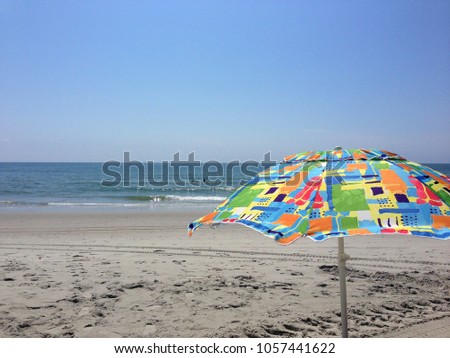 Colorful beach umbrella at the seashore.