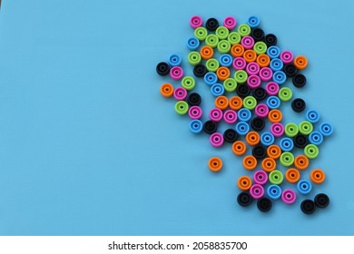 Colorful Beads From A Broken Abacus On A Blue Background