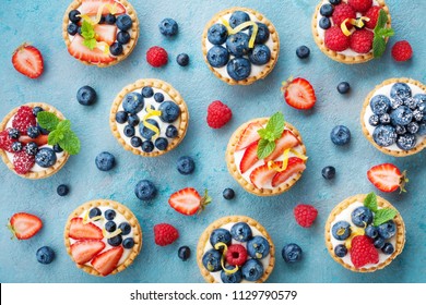 Colorful Berry Tartlets Or Cake For Kitchen Pattern. Pastry Dessert From Above.