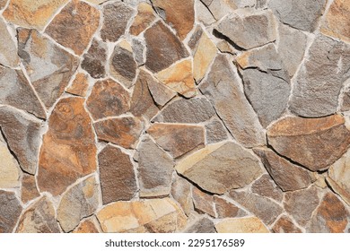 It is colorful big stones in a wall. The background is unfocused with art noise. This is a texture for designer. 