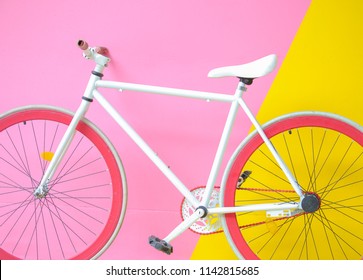 Colorful bike on pastel color wall.