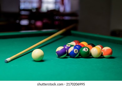 Colorful billiard balls and cue on a green table. billiard game in the club. snooker,
