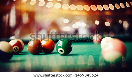 Colorful billiard balls on a green billiard table. Gambling game of Billiards. Billiard ball with number nine.