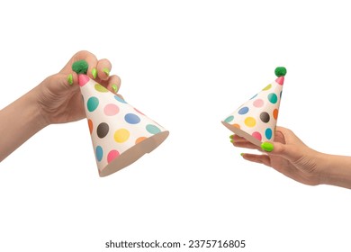 Colorful birthday cap in woman hands isolated on a white background