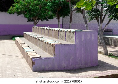 Colorful bleachers in a park. Bleachers for kids to sit in a public park so as to watch sportive activities.
