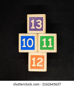 colorful blocks with numbers ten, eleven, twelve and thirteen, this is a toy for children to learn to recognize colors and numbers, black background