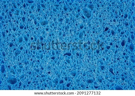 colorful blue foam rubber sponges isolated on a white background for washing dishes.
