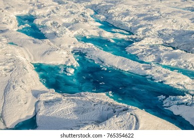 Colorful blue meltwater pools at Columbia Glacier in Alaska - aerial - Powered by Shutterstock