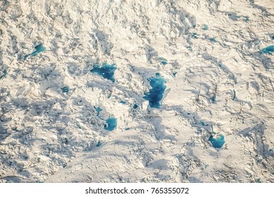 Colorful blue meltwater pools at Columbia glacier in Alaska - aerial - Powered by Shutterstock