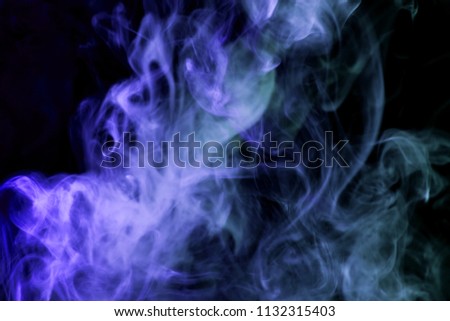 Colorful  blue smoke  on a black isolated background. Background from the smoke of vape
