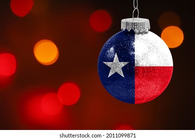 Colorful blurred background and applied the flag of State of Texas on the New Year's toy. New Year 2022 Celebration