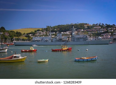 Colorful Boats In Front Of The British Royal Navy Frigate Hms Kent F78 In The Dartmouth Harbour, England