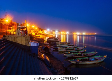 Colorful Boats And Ganges River Bank In Varanasi City In India At Night