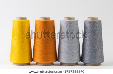 colorful bobbins of thread isolated on white background.