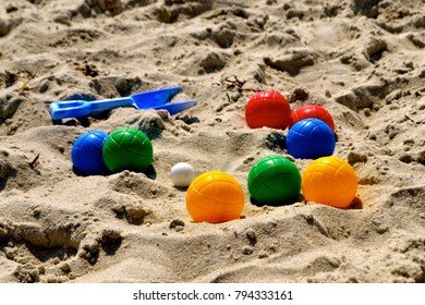 Colorful Bocce Balls On Sandy Beach