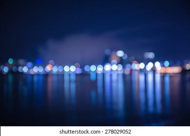 Colorful Bokeh Of City Skyline From The Sea In Night Time