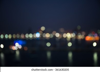 Colorful Bokeh Of City Skyline From The Sea In Night Time
