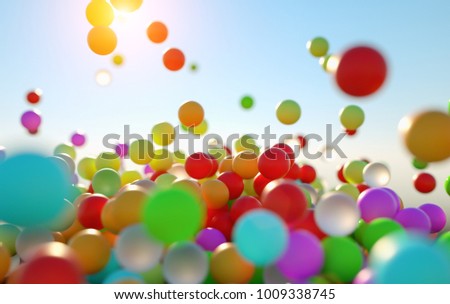 colorful bouncing balls outdoors against blue sunny sky