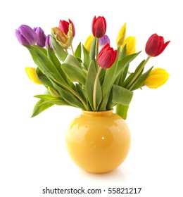 Colorful bouquet tulips in yellow vase on white background