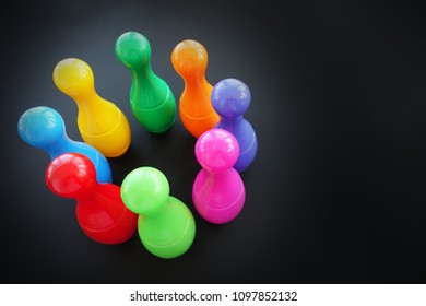 Colorful Bowling Pins Or Skittles On Dark Background, Top View

