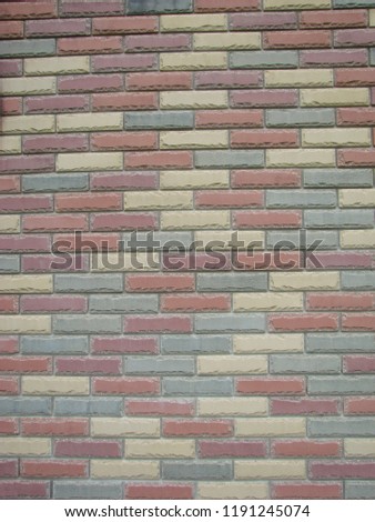 Colorful brick wall pattern, painted bricks as urban design texture.