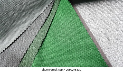 colorful bright fabric pattern palette texture samples in grey and green tone for interior material selection. matching color and texture of drapery material. close up upholstery catalog for choosing.