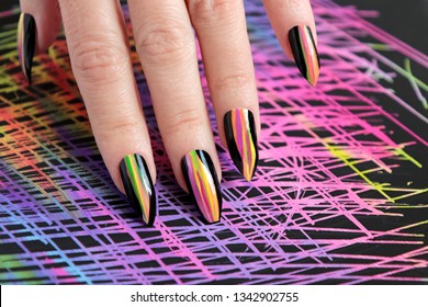 Colorful bright manicure and different sharp shape nails framed and black lacquer Nail art  Creative nail design color background 