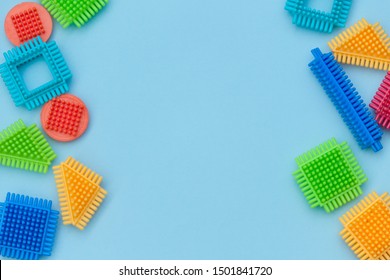 Colorful Bristle Blocks On Blue Background. Copy Space, Flat Lay.