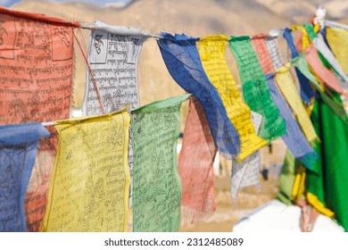 Colorful Buddhism prayer flags, lungta with Buddism symbols in Ladakh, India	
