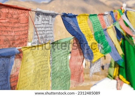 Colorful Buddhism prayer flags, lungta with Buddism symbols in Ladakh, India	
