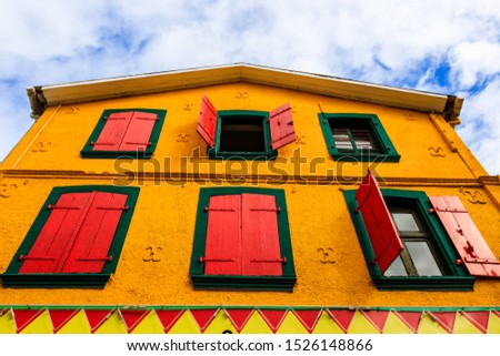 A colorful building in the downtown of Fort de France, Martinique. Colorful house, windows with wooden shutters.