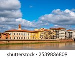 Colorful buildings along Lungarno Ranieri Simonelli in Pisa, Italy, located along the northern bank of the Arno River. 