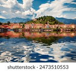 Colorful buildings of Bellagio town reflected int he calm waters of Como lake, Italy, Europe. Wonderful summer cityscape of Bellagio resort. Traveling concept background.