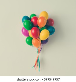 Colorful Bunch Of Easter Egg Balloons On Bright White Background. Minimal Creative Concept. Flat Lay.