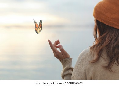 colorful butterfly is laying on a woman's hand
