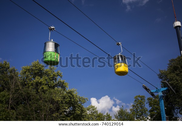 Colorful cable cars at a\
state fair.