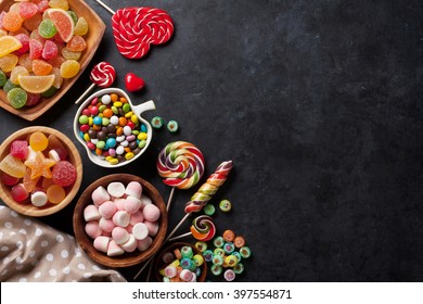 Colorful candies, jelly and marmalade on stone background. Top view with copy space - Shutterstock ID 397554871
