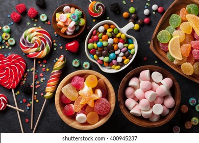 Colorful candies, jelly and marmalade on stone background. Top view