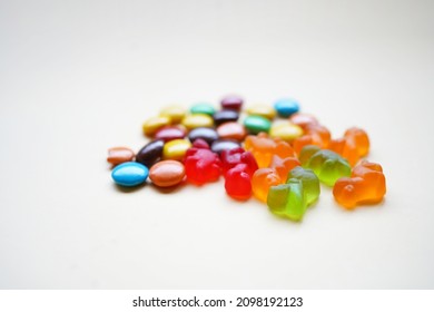 Colorful Candies On White Background With Copy Space. Sticky Candy Damage Your Child's Teeth. The Biggest Problem Is Having The Candy Get Stuck In Between The Teeth.