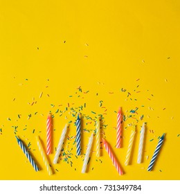 Colorful Candle For Birthday Party On A Yellow Background, Flat Lay, Top View