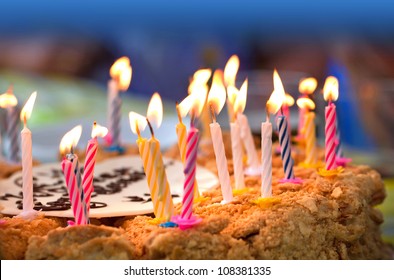 Colorful Candles On  Birthday Cake Above Dark Background