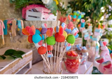 Colorful candy and gummy kabobs on a wedding party, no people shown