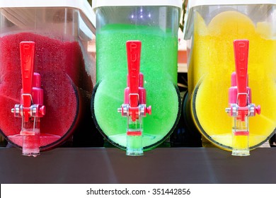 Colorful canisters of refreshing frosty cold slushy ice drinks